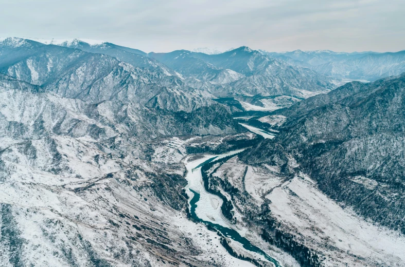 a snow covered mountain with a river running through it, by Simon Gaon, pexels contest winner, sōsaku hanga, aerial viewyoji shinkawa, pyongyang, fine art print, cold hues