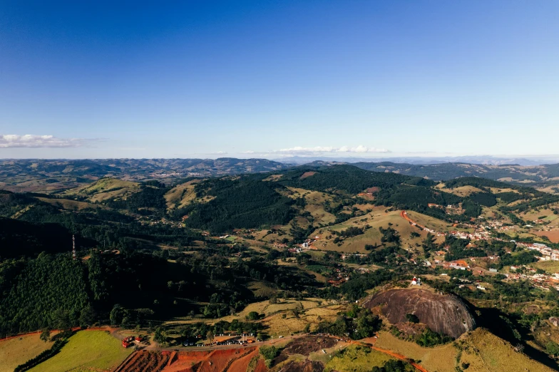 a group of people standing on top of a lush green hillside, by Peter Churcher, pexels contest winner, renaissance, brazil, panorama distant view, small town surrounding, dan eder