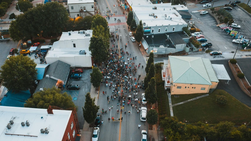 a large group of people walking down a street, by Meredith Dillman, unsplash contest winner, aerial footage, marathon, california;, sick