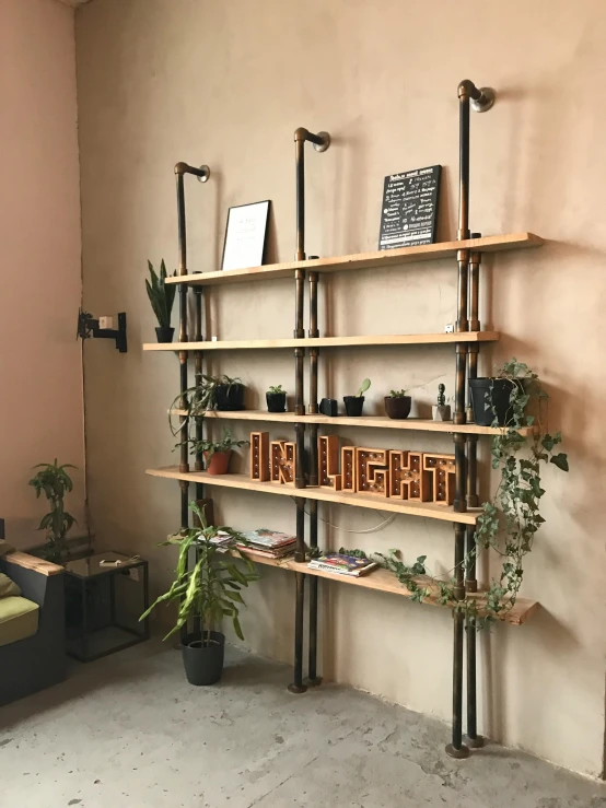 a living room filled with furniture and plants, a picture, with pipes attached to it, profile image, shelf, in a coffee shop