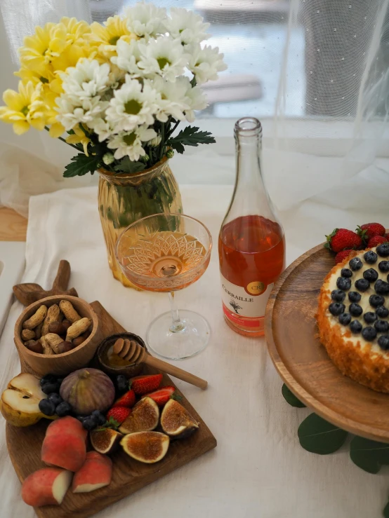 a table topped with plates of food next to a vase of flowers, inspired by Jacopo Bellini, pexels contest winner, fruit, honey, having a picnic, full product shot