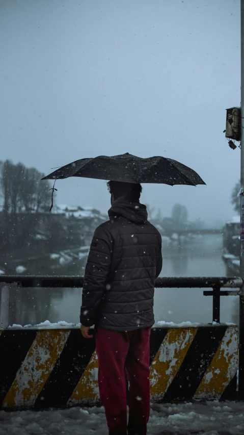 a person standing in the snow with an umbrella, by Tobias Stimmer, on a bridge, monsoon, slide show, thoughtful )