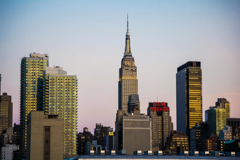 the empire state building towering over the city of new york, by Carey Morris, pexels contest winner, on a rooftop, close up shot from the side, slide show, conde nast traveler photo