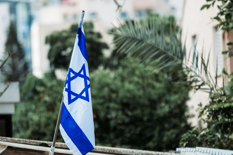 a blue and white flag sitting on top of a window sill, pexels, tel aviv street, avatar image, sukkot, benjamin netanyahu