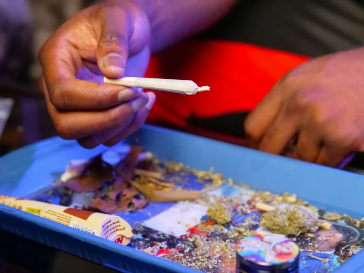 a close up of a person holding a toothbrush, by artist, process art, smoking a bowl of hash together, lil uzi vert, cigarrette boxes at the table, photograph credit: ap