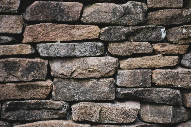 a close up view of a stone wall, unsplash, instagram picture, brown, stacked, grey