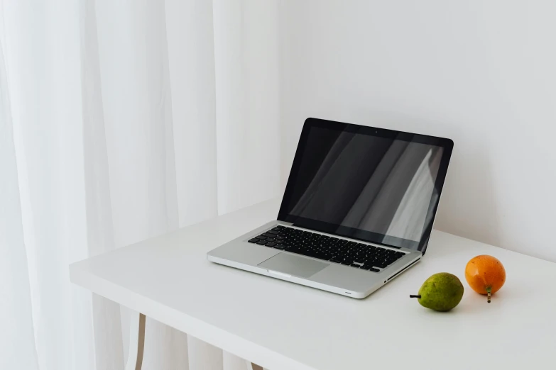 a laptop computer sitting on top of a white table, trending on pexels, pear, single portrait, background image, simple form