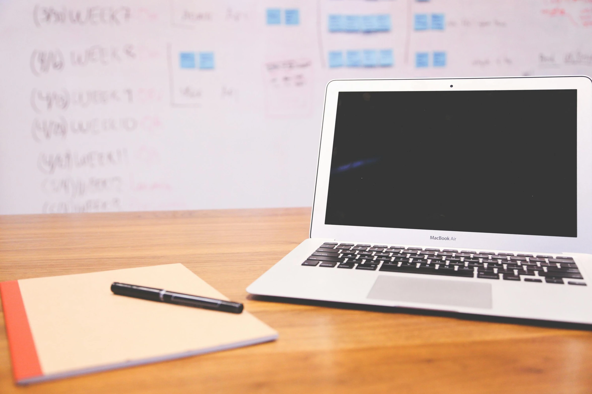 a laptop computer sitting on top of a wooden desk, pexels, whiteboards, background image, with notes, featured