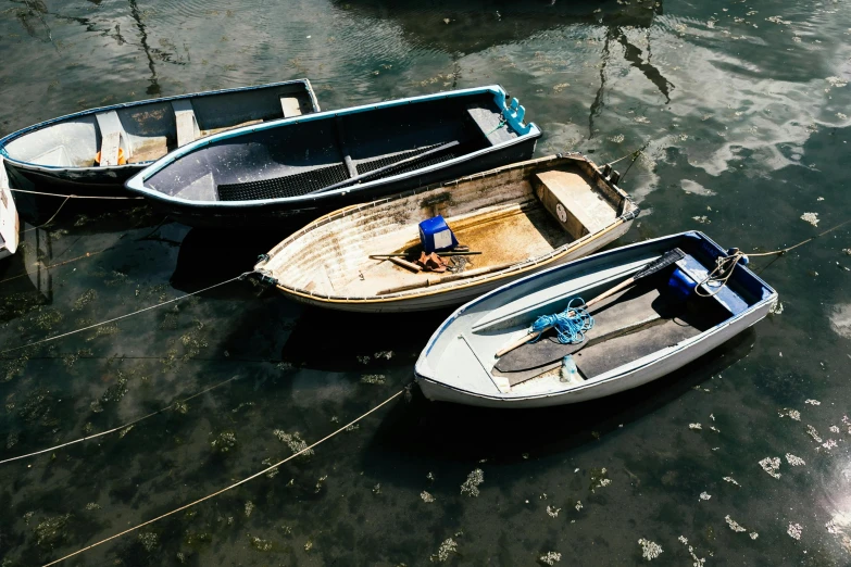 a number of small boats in a body of water, pexels contest winner, photorealism, threes, well worn, thumbnail, cornwall