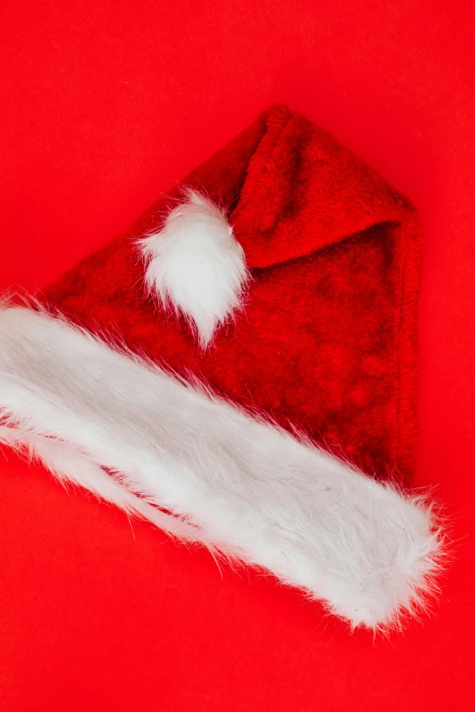 a red santa hat on a red background, an album cover, pexels, 2995599206, square, high quality photo, synthetic fur