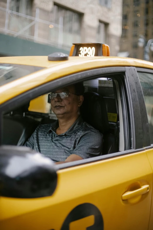 a man sitting in the driver's seat of a taxi, by Michael Goldberg, square, leslie zhang, profile photo, ap press photo