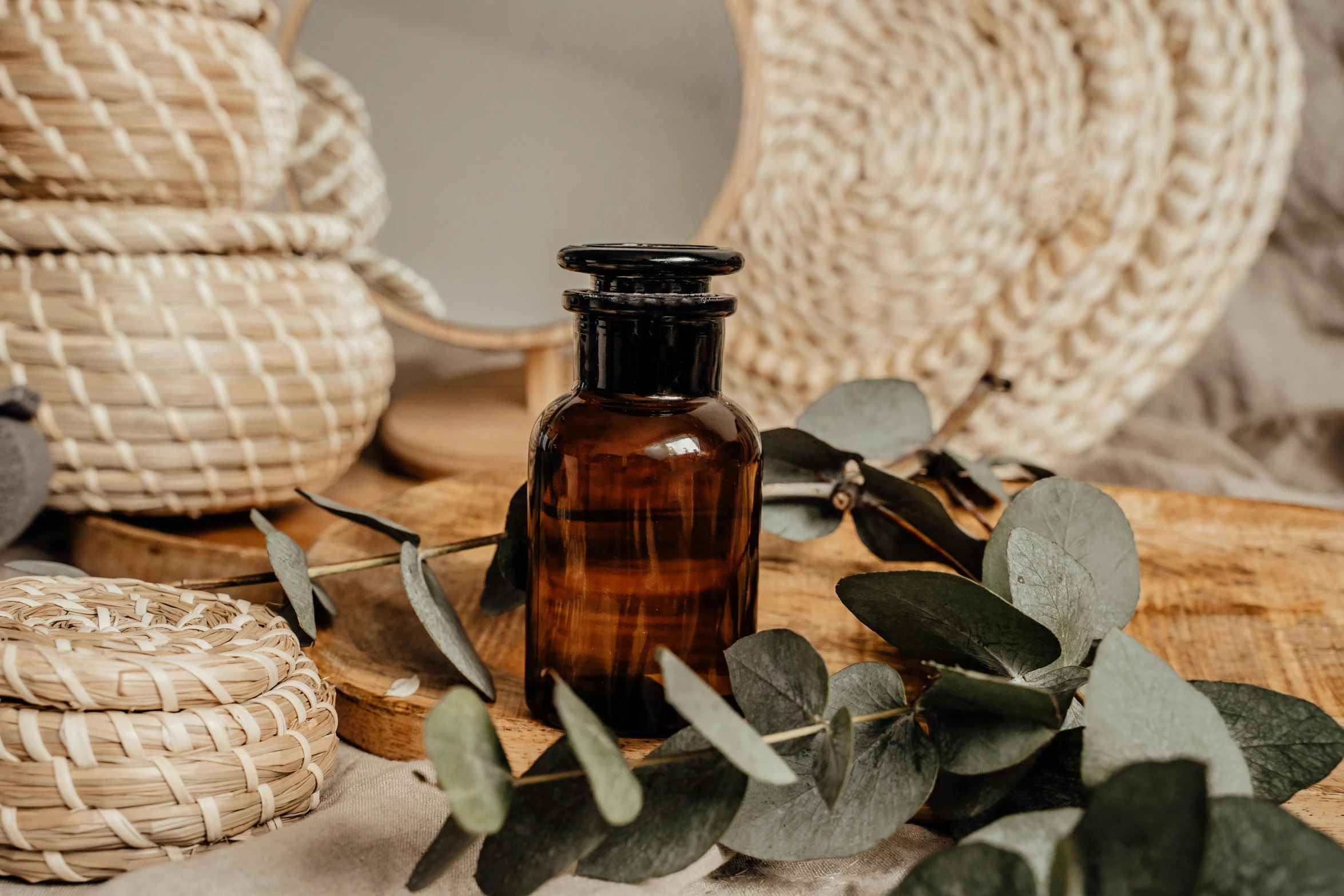 a bottle of essential oil sitting on top of a table, by Emma Andijewska, trending on pexels, arts and crafts movement, eucalyptus, brown, thumbnail, handcrafted