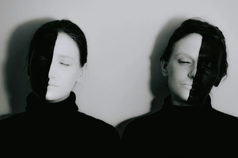 a couple of people standing next to each other, a black and white photo, inspired by Anna Füssli, unsplash, purism, both faces visible, split in half, partially masked, different women's faces