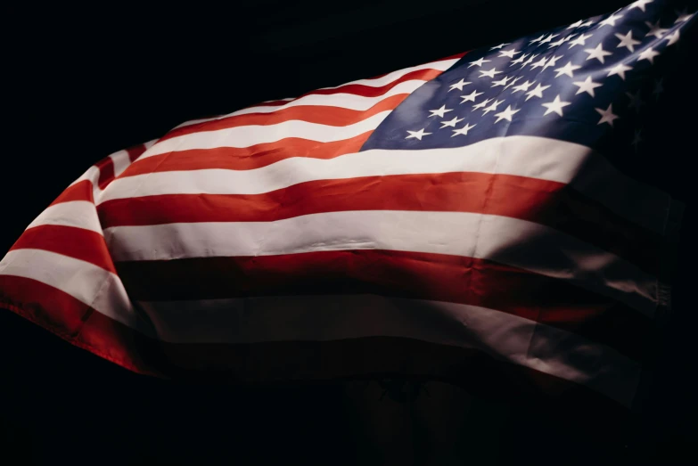an american flag blowing in the wind, a portrait, unsplash, on black background, instagram photo, [ cinematic, instagram post
