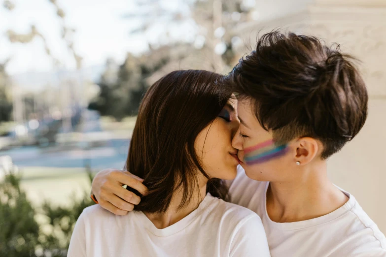 a man and a woman standing next to each other, trending on pexels, happening, lesbian kiss, zeen chin and terada katsuya, multicoloured, sydney park