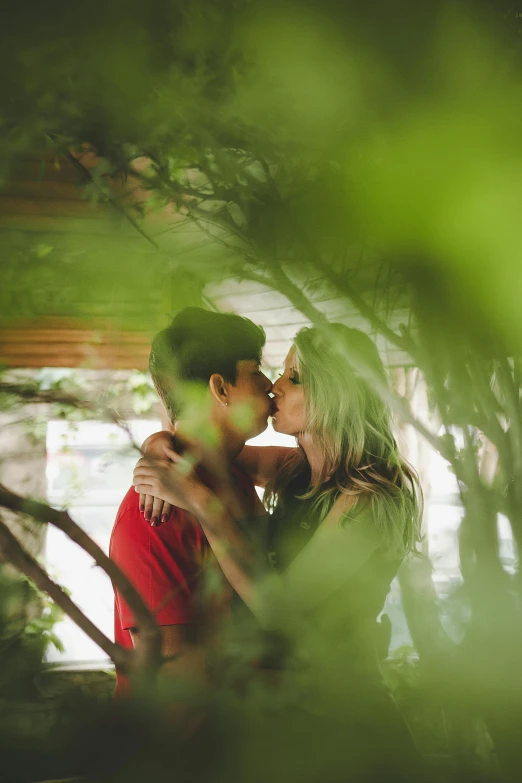 a man and a woman standing next to each other, a picture, inspired by Elsa Bleda, pexels contest winner, romantic greenery, making out, in a tree house, hispanic