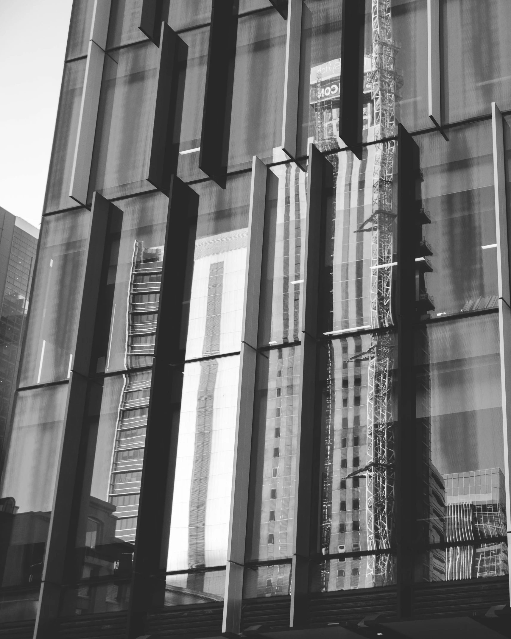 a black and white photo of a tall building, unsplash, full of glass. cgsociety, glossy reflections, square lines, te pae