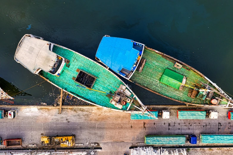 a couple of boats sitting on top of a body of water, by Jang Seung-eop, pexels contest winner, shipping docks, top-down shot, thumbnail, hyper - detailed color photo