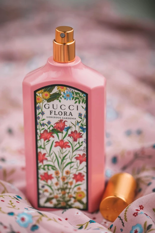 a bottle of perfume sitting on top of a bed, floral patterned skin, thumbnail, pink body, floro details