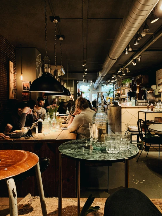 a group of people sitting at a table in a restaurant, a photo, by Jan Tengnagel, pexels contest winner, cafe interior, thumbnail, gif, multiple stories