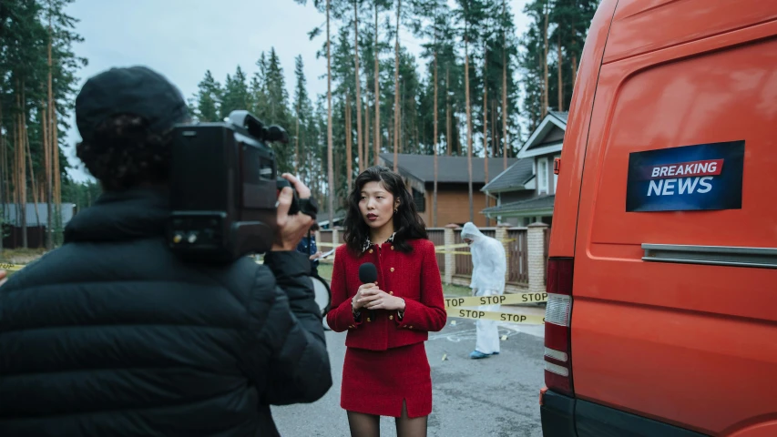 a woman in a red dress standing in front of a van, by Julia Pishtar, pexels contest winner, crime scene, giving an interview, sangsoo jeong, finland