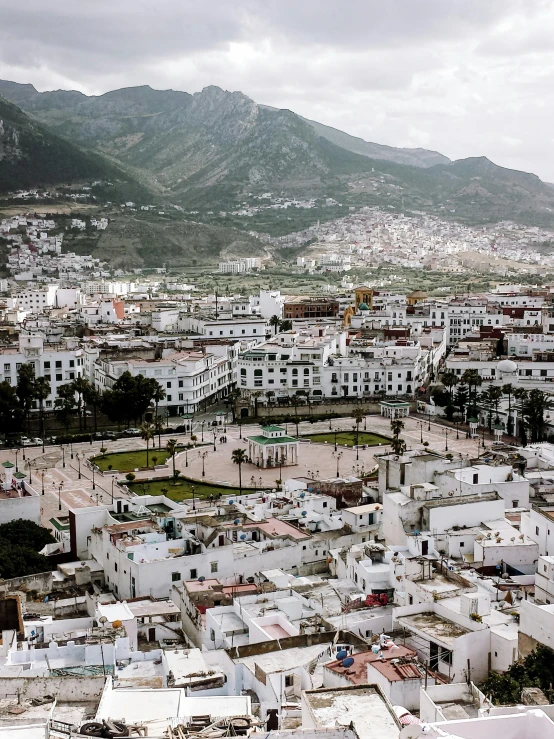 a view of a town from the top of a hill, by Julia Pishtar, moroccan mosque, square, hq 8k cinematic, grey