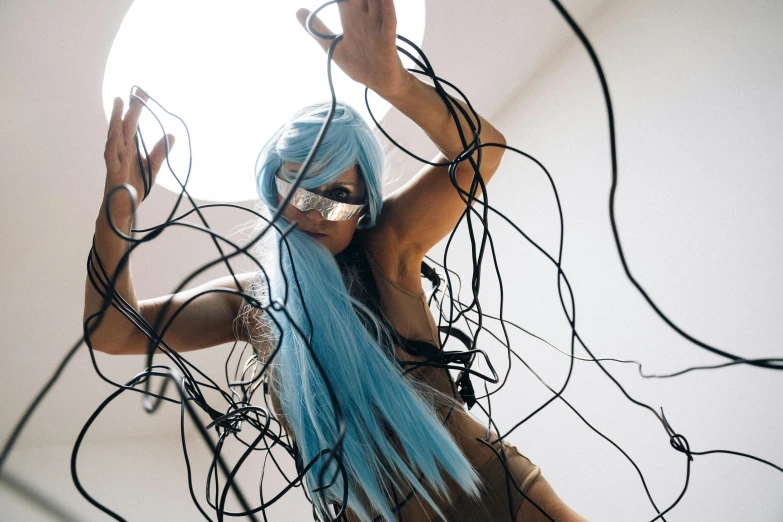 a woman with blue hair is surrounded by wires, unsplash, conceptual art, jessica nigri, dance, cardboard, 2000s photo