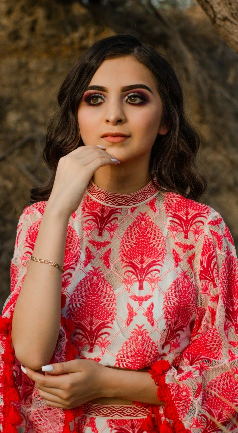 a woman standing next to a tree in a red and white dress, trending on pexels, renaissance, beautiful young himalayan woman, high angle closeup portrait, tunic, promotional image