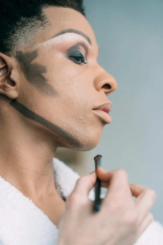 a woman is putting makeup on her face, inspired by Mac Conner, renaissance, androgynous male, thick pigmented smoke, kara walker, production photo