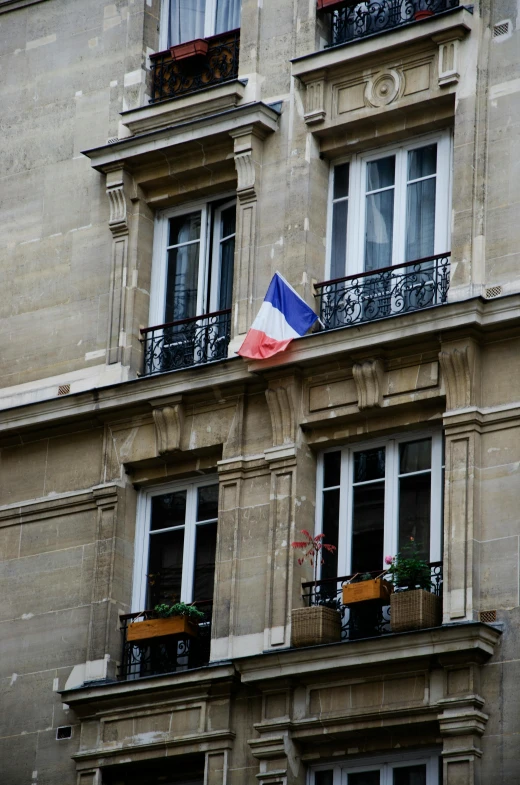 a building with a french flag flying in front of it, flickr, sitting in french apartment, square, patriotic!
