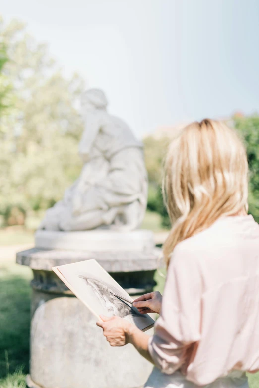 a woman reading a newspaper in front of a statue, a marble sculpture, inspired by Enrique Simonet, pexels contest winner, visual art, pastel artwork, 4k photograph of painting, in the garden, sketching