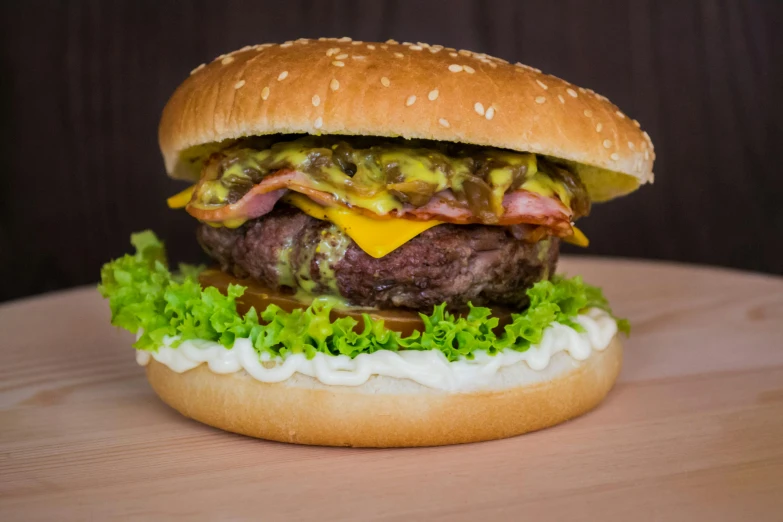 a hamburger sitting on top of a wooden table, profile image