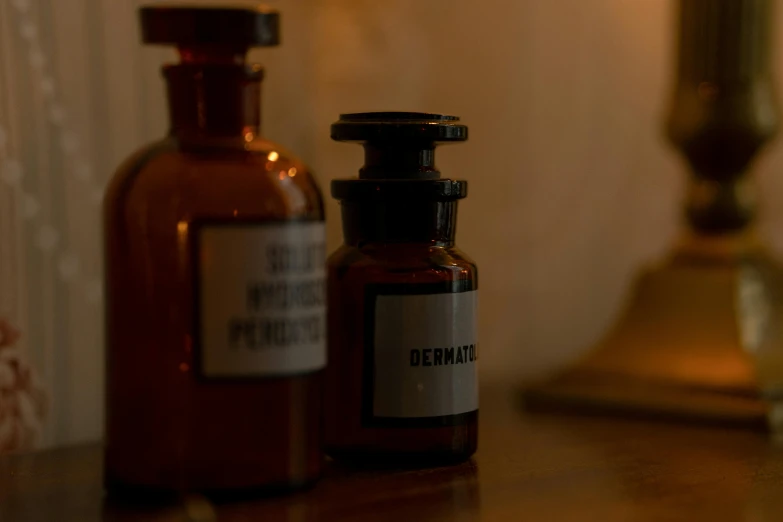 a couple of bottles sitting on top of a table, unsplash, renaissance, medical labels, dimly lit interior room, brown, doctor