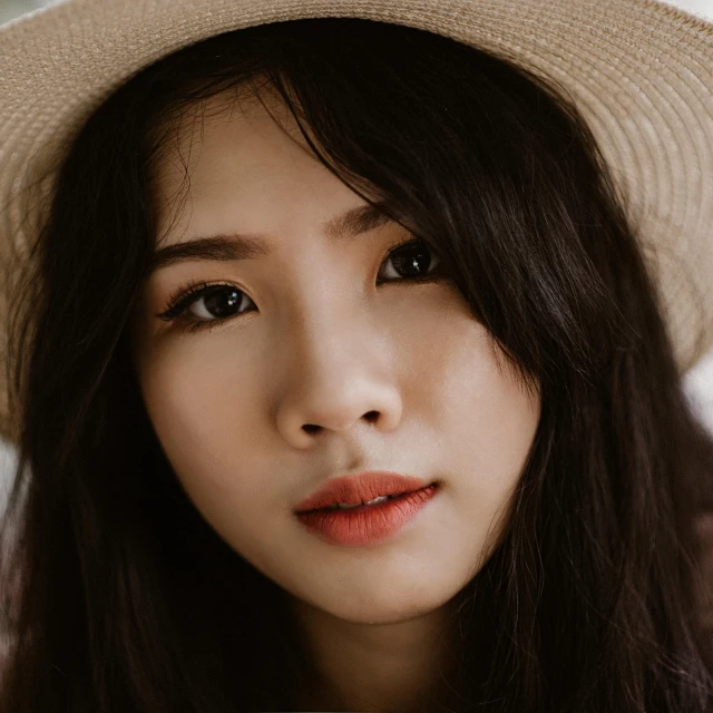 a close up of a person wearing a hat, half asian, pretty oval face, thin lips, malaysian