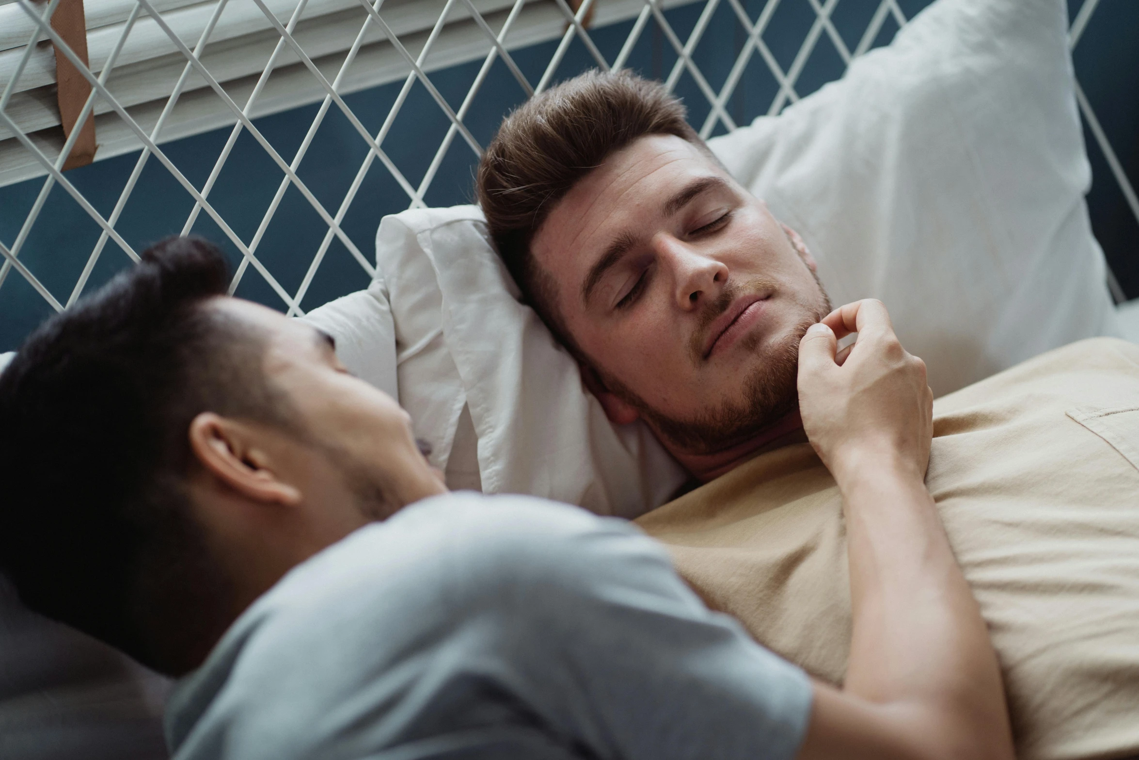 a couple of men laying in bed next to each other, trending on pexels, from the elbow, anaesthetic, lachlan bailey, comforting