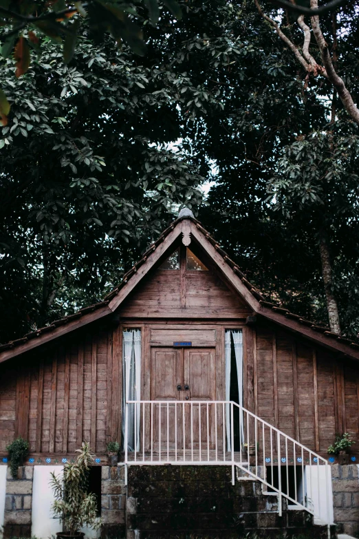 a small wooden building sitting in the middle of a forest, unsplash, sumatraism, wood door, ✨🕌🌙, glamping, church