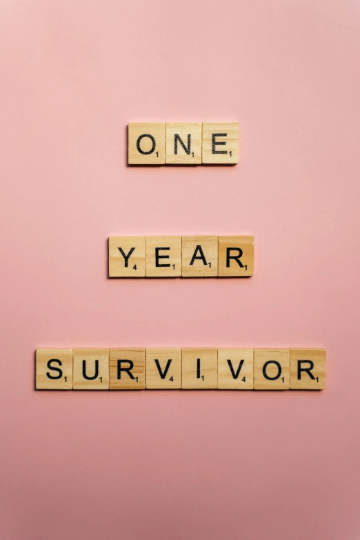 scrabbles spelling one year survivor on a pink background, multiple stories, lone survivor, background image, thumbnail