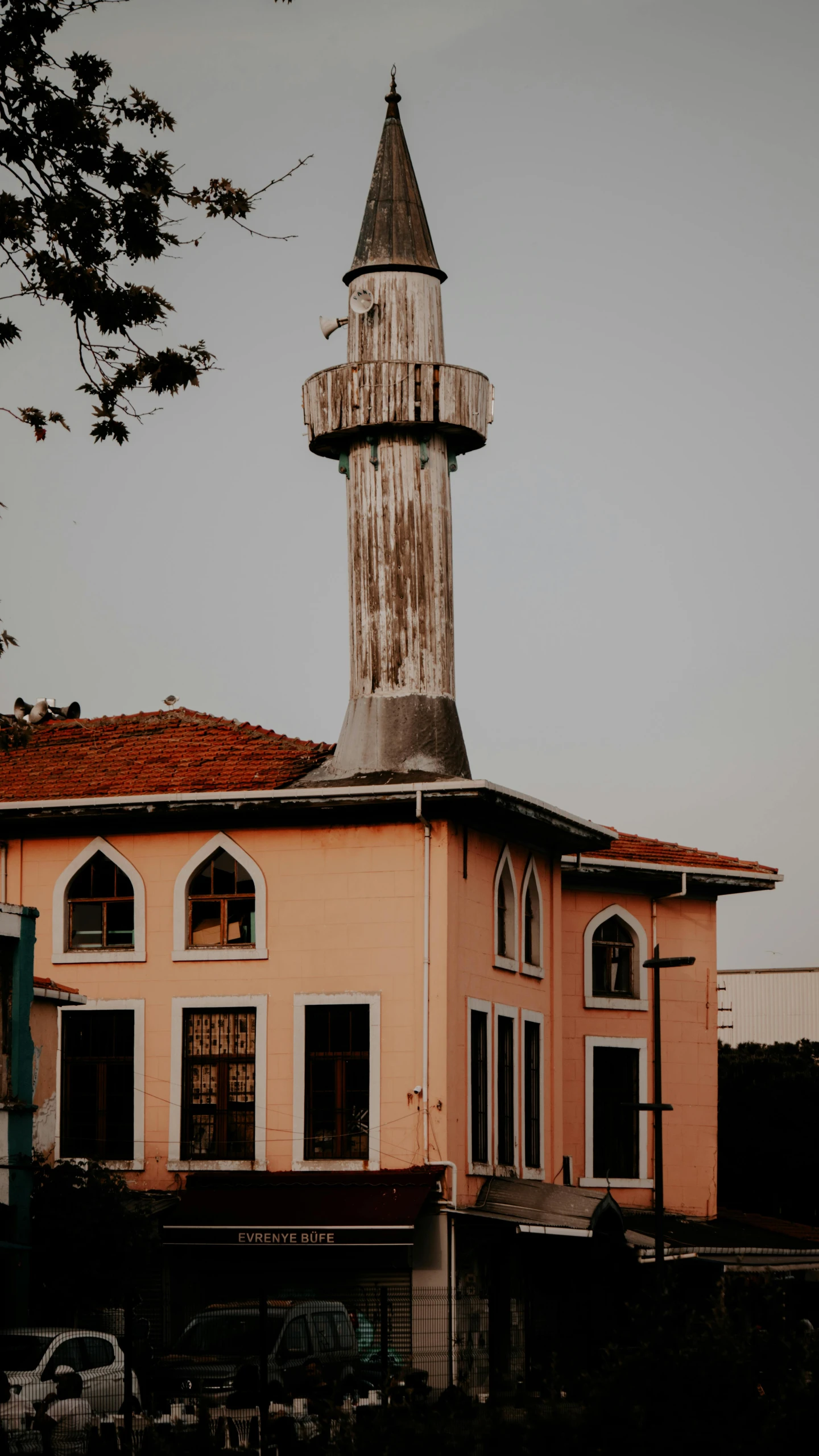 a tall building with a clock tower on top of it, a colorized photo, by Ismail Acar, pexels contest winner, hurufiyya, rounded roof, trending on vsco, mosque, 90's photo