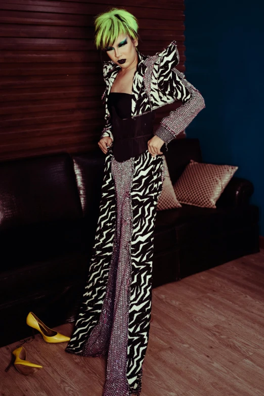 a woman with green hair standing in front of a couch, an album cover, by Myra Landau, happening, zebra stripes, long luxurious gown, full body photograph, wearing disco suit