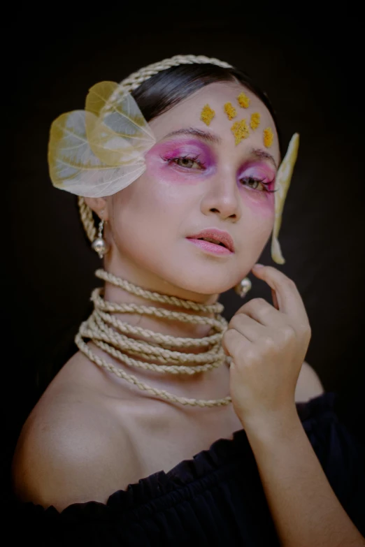 a woman in a black dress holding a pair of scissors, a colorized photo, inspired by reyna rochin, trending on pexels, art photography, wearing seashell attire, wearing gold detailed choker, creative colorfull - makeup, assamese aesthetic