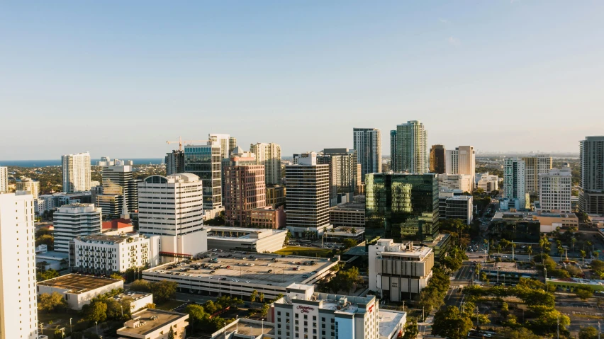 an aerial view of a city with tall buildings, palms and miami buildings, slide show, taken at golden hour, high resolution print :1 cmyk :1