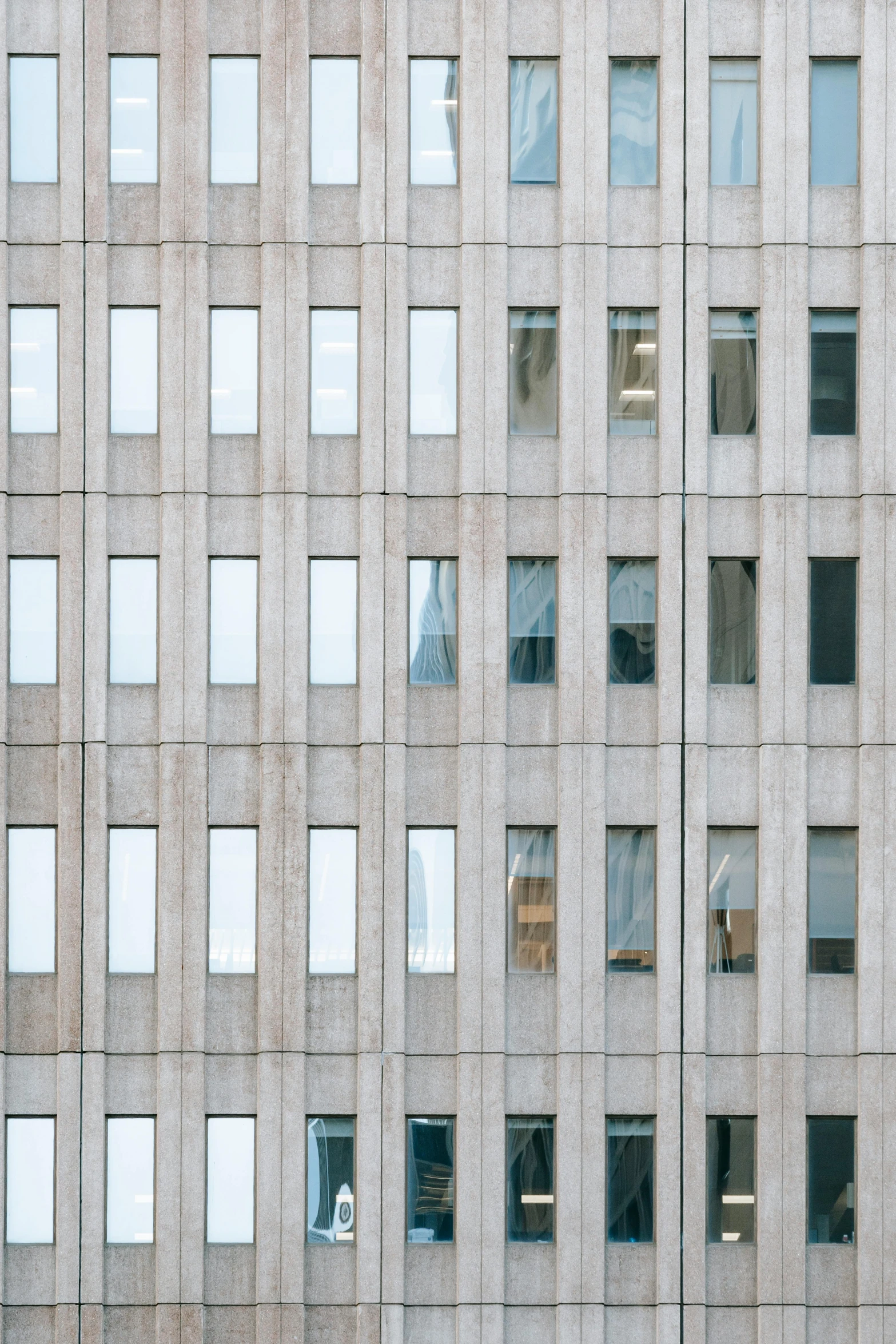 a group of people standing in front of a tall building, an album cover, inspired by Andreas Gursky, unsplash, brutalism, steel window mullions, detail texture, cubicles, window ( city )