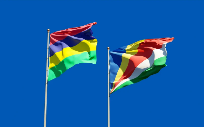 two flags blowing in the wind against a blue sky, inspired by Georg Friedrich Schmidt, shutterstock contest winner, hurufiyya, multi - coloured, reunion island, high polygon, aida muluneh