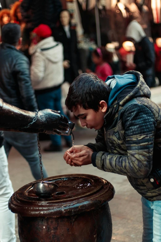 a man is pouring water into a barrel, a picture, pexels contest winner, hurufiyya, cute boy, istanbul, square, offering a plate of food