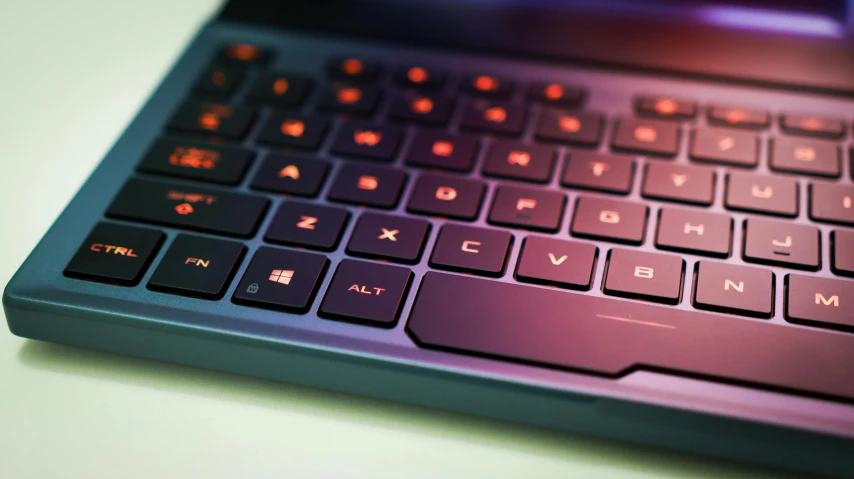 a close up of a laptop keyboard on a table, by Carey Morris, shutterstock, computer art, blue and orange rim lights, skin on the gaming pc, instagram post, low-angle shot