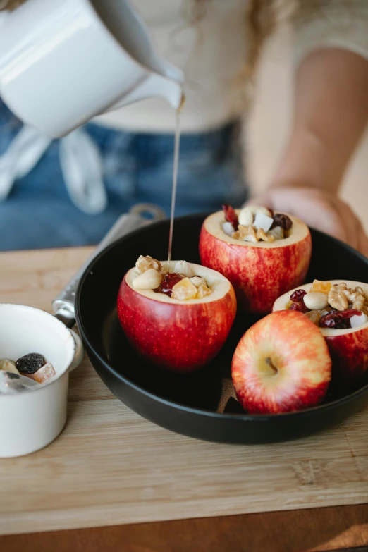 a person pouring milk on apples in a pan, by Julia Pishtar, trending on unsplash, walnuts, miniatures, square, 15081959 21121991 01012000 4k