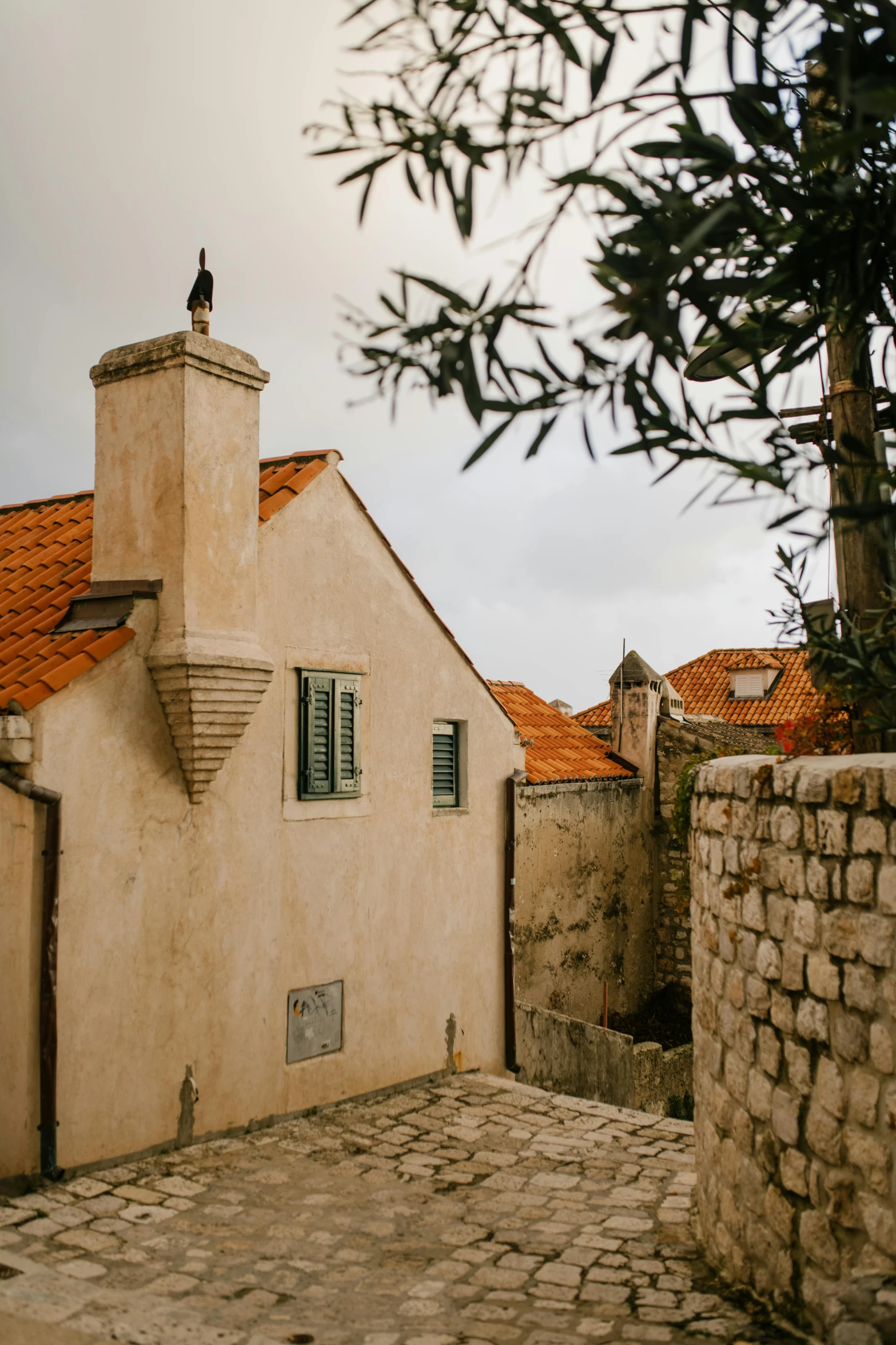 a couple of buildings that are next to each other, trending on unsplash, renaissance, stone roof, boka, conde nast traveler photo, taken in the early 2020s