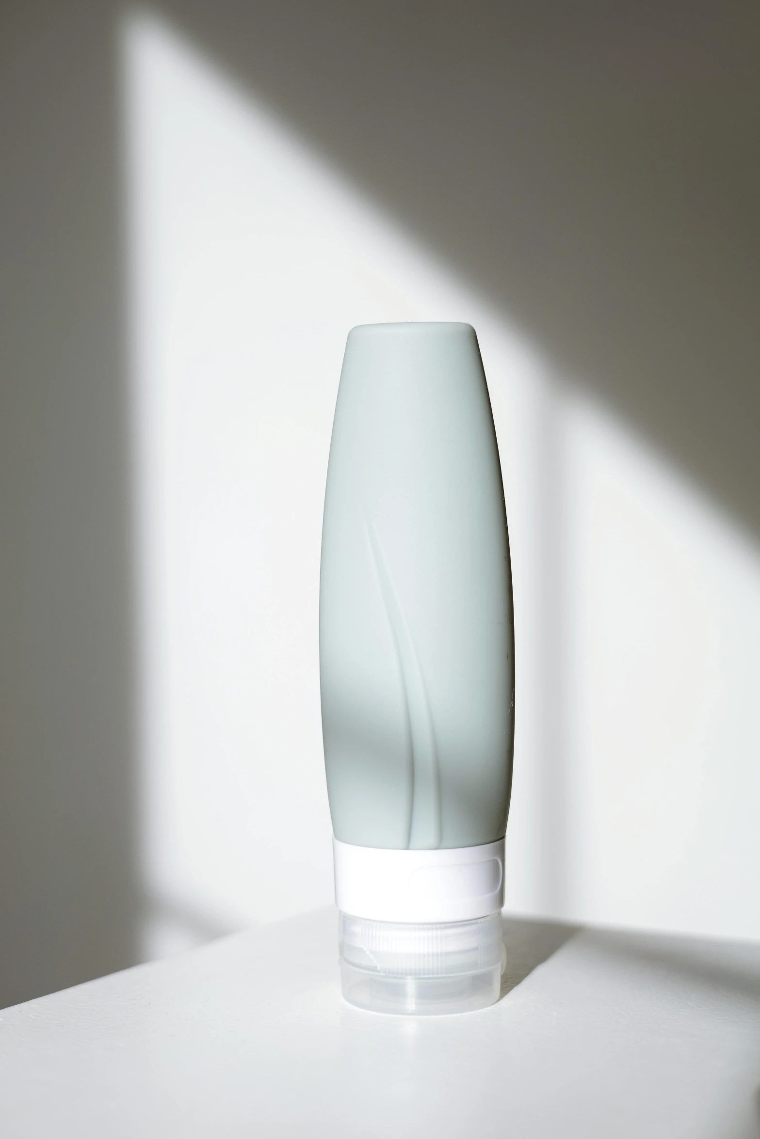 a glass vase sitting on top of a white table, city mist softlight, diffused natural skin glow, detailed product image, mint