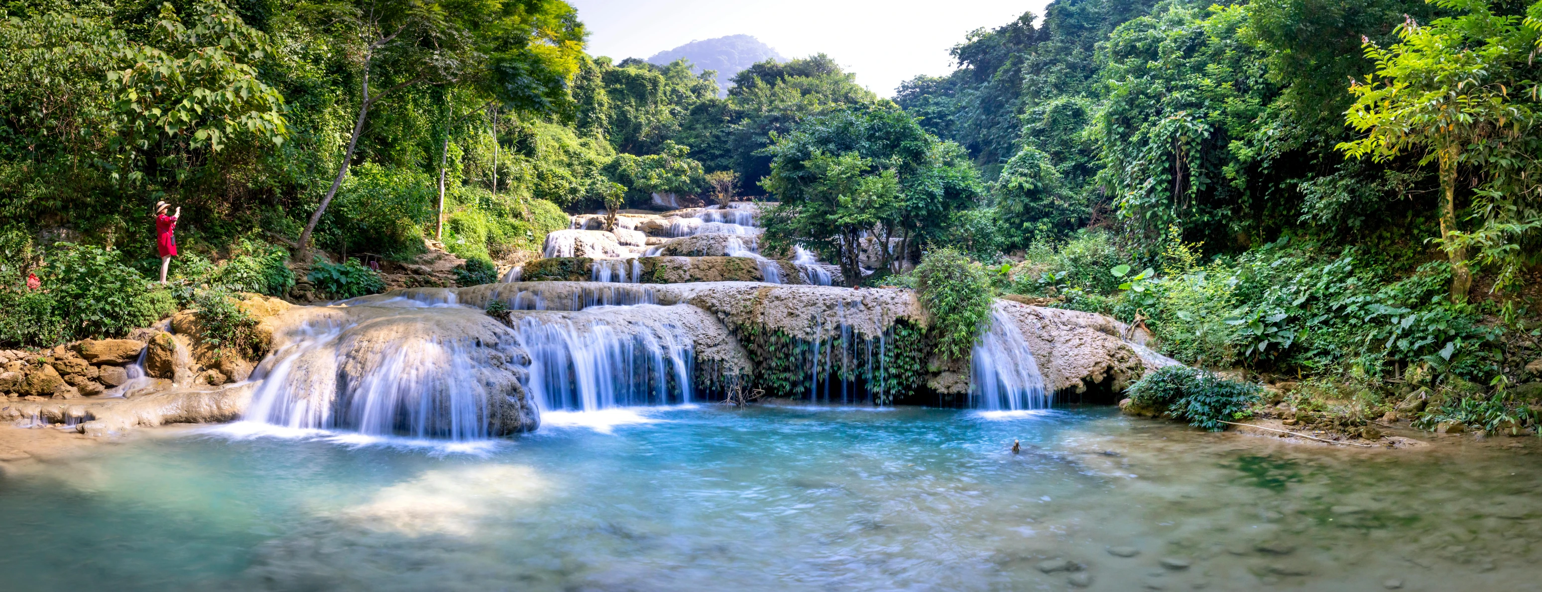 a waterfall in the middle of a lush green forest, pexels contest winner, sumatraism, white travertine terraces, avatar image, blue waters, 90s photo