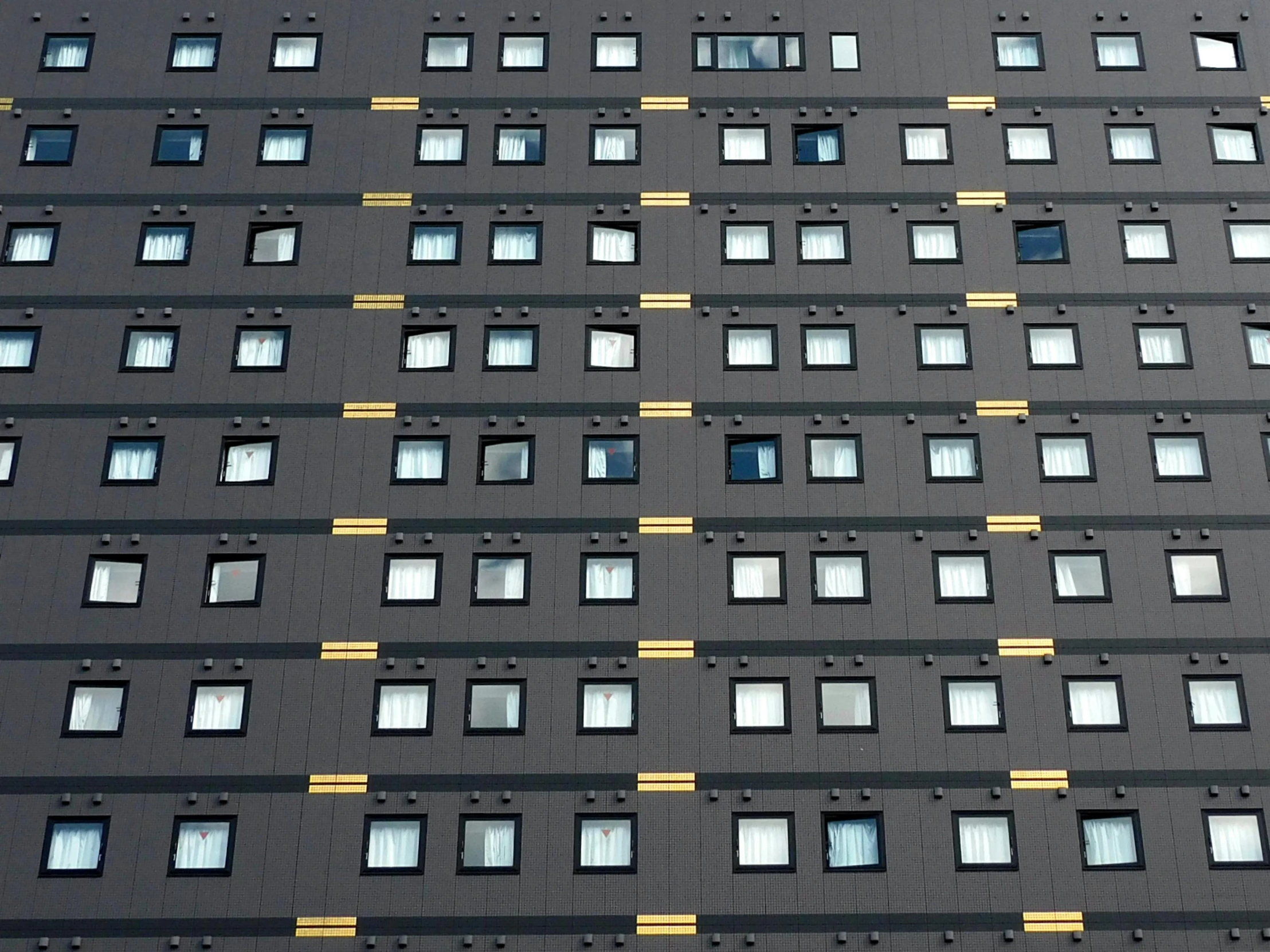 a very tall building with lots of windows, by Yasushi Sugiyama, unsplash, bauhaus, hotel room, panel of black, taken in the 2000s, ornamented